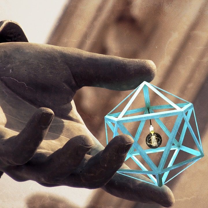 hand holding a geometric shape