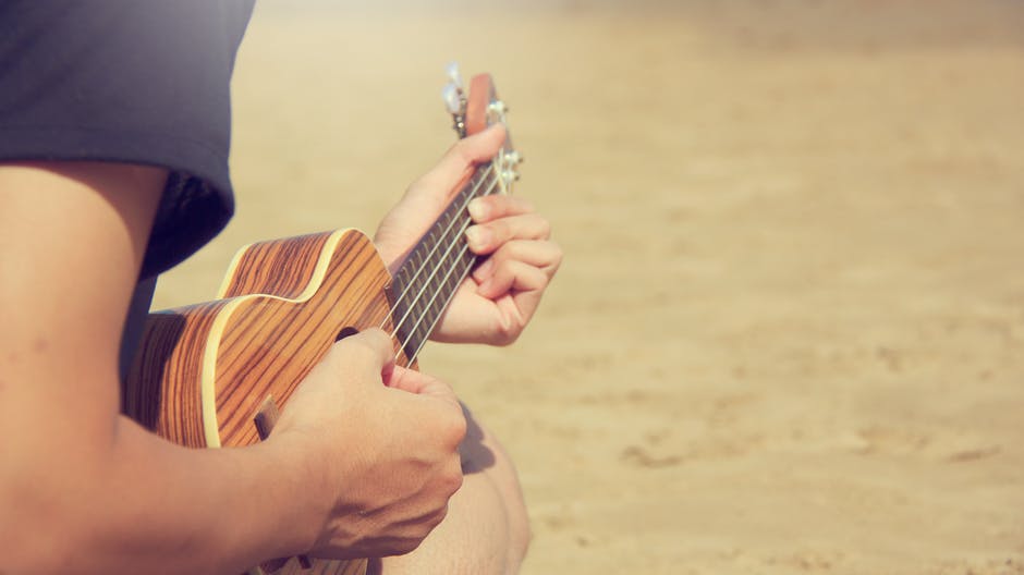 man playing ukulele