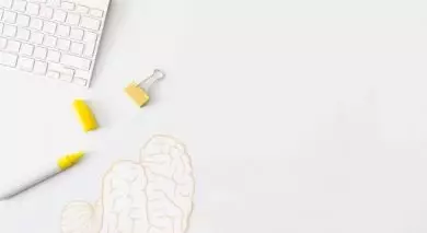keyboard on the desk with a paper picture of brain